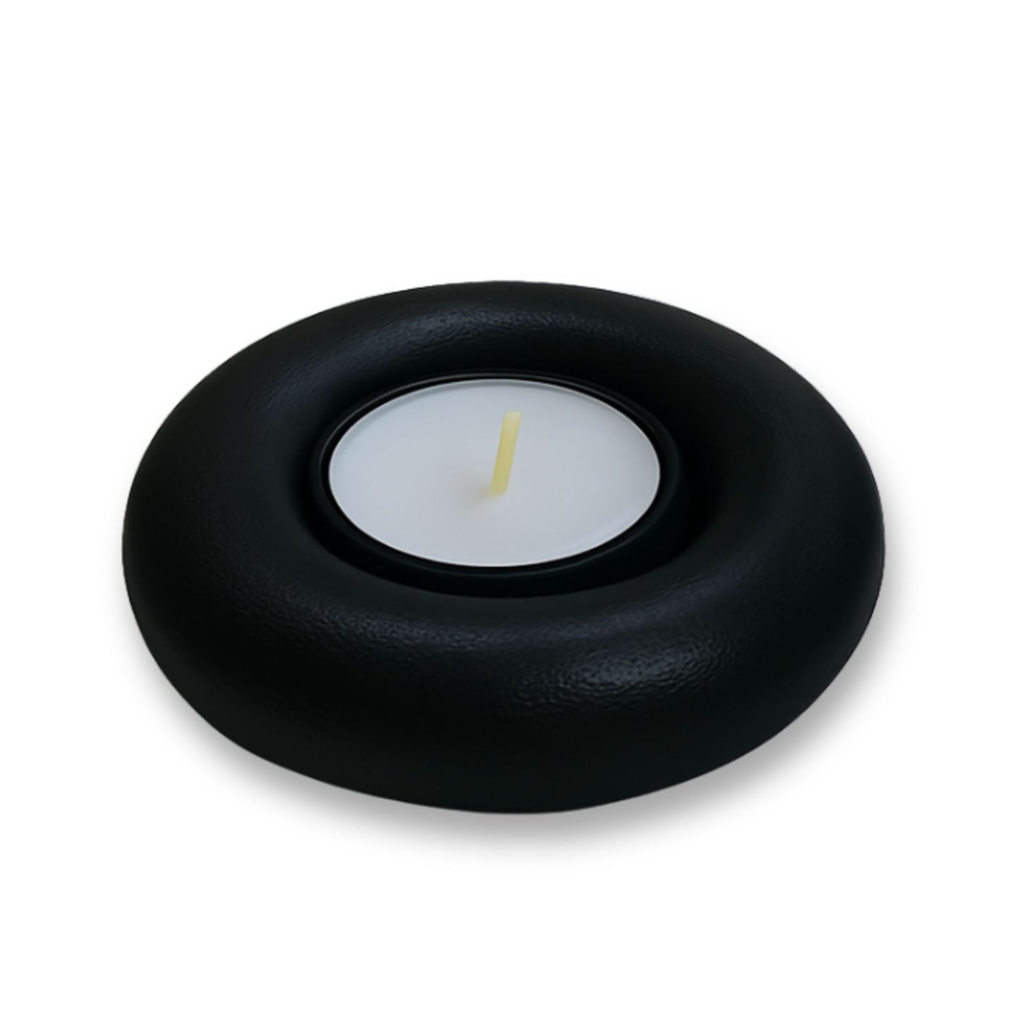 Black candle holder with a white candle on a white background