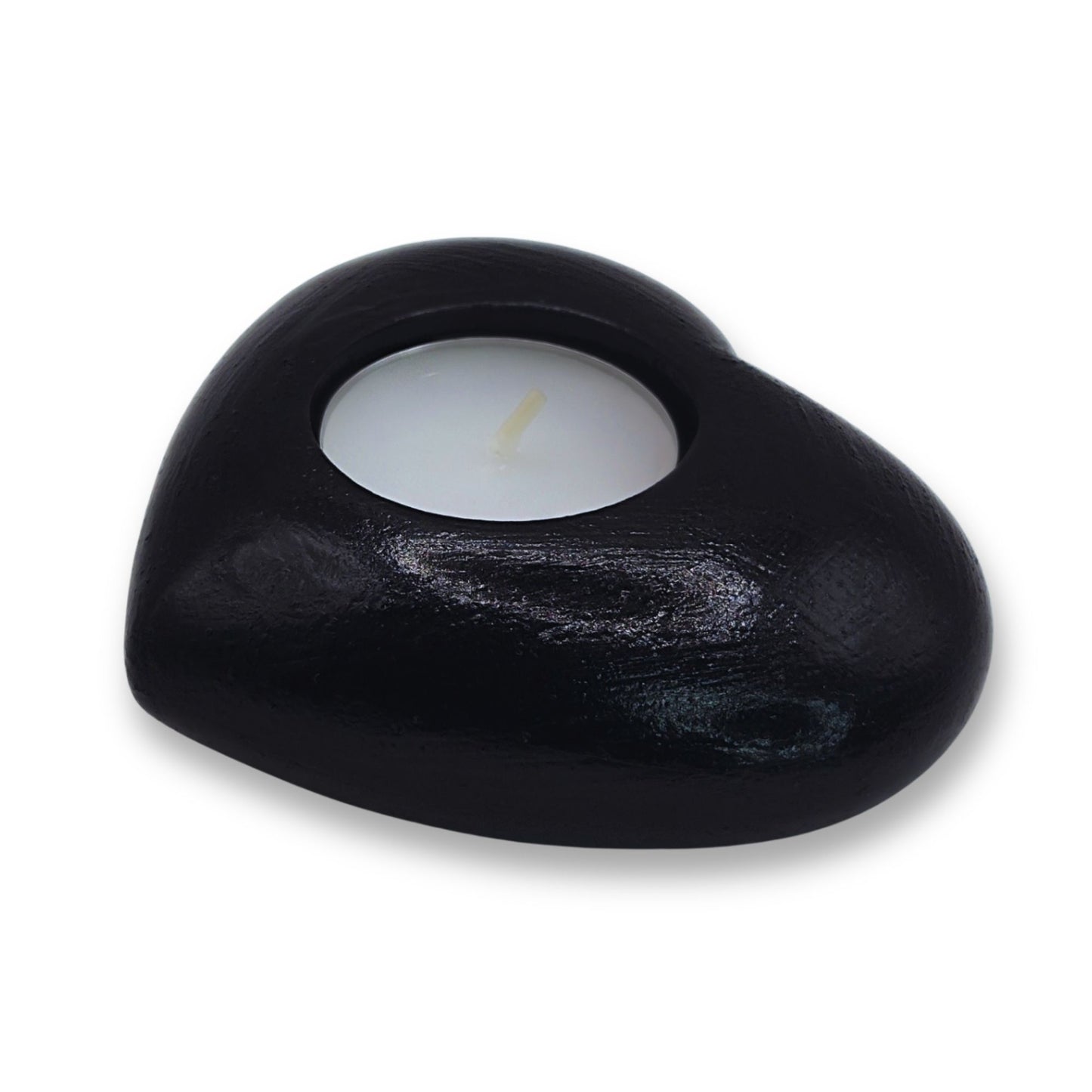 Black candle holder with a lit candle on a white background