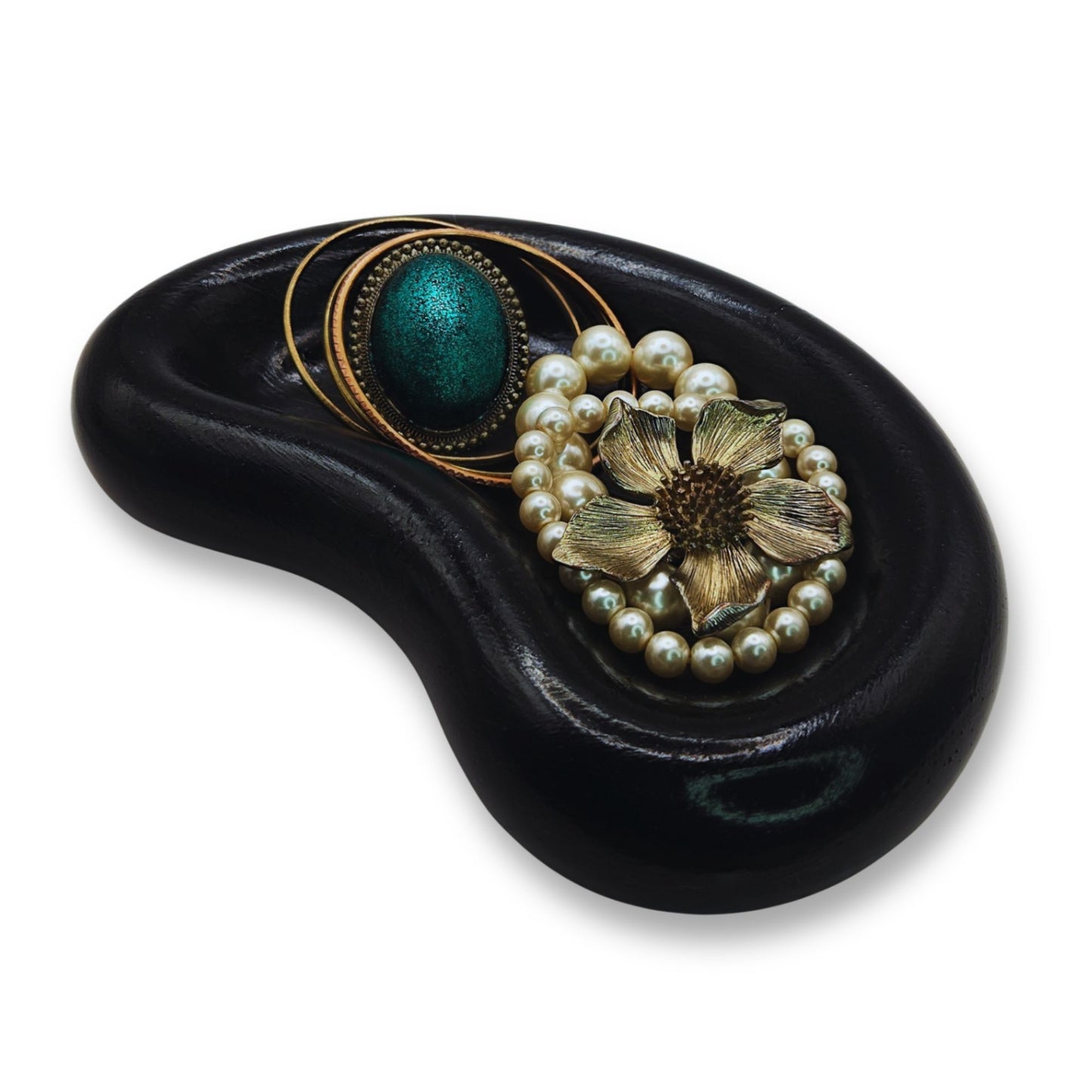 Decorative item with floral and pearl design on a black base