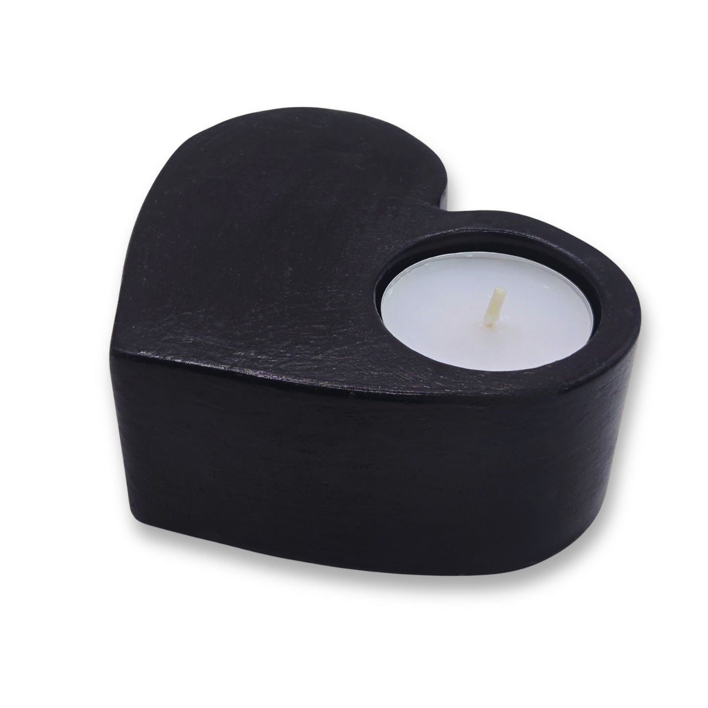 Black heart-shaped candle holder with a lit candle on a white background