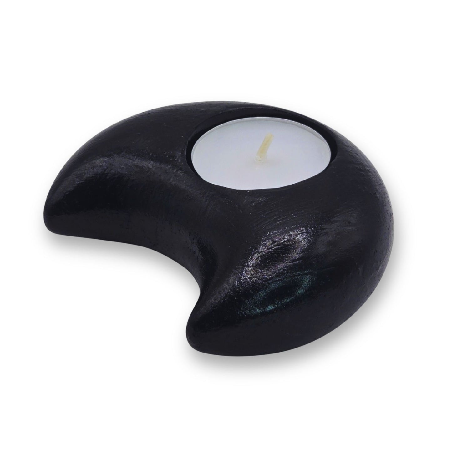 Black crescent-shaped candle holder with a lit candle inside on a white background