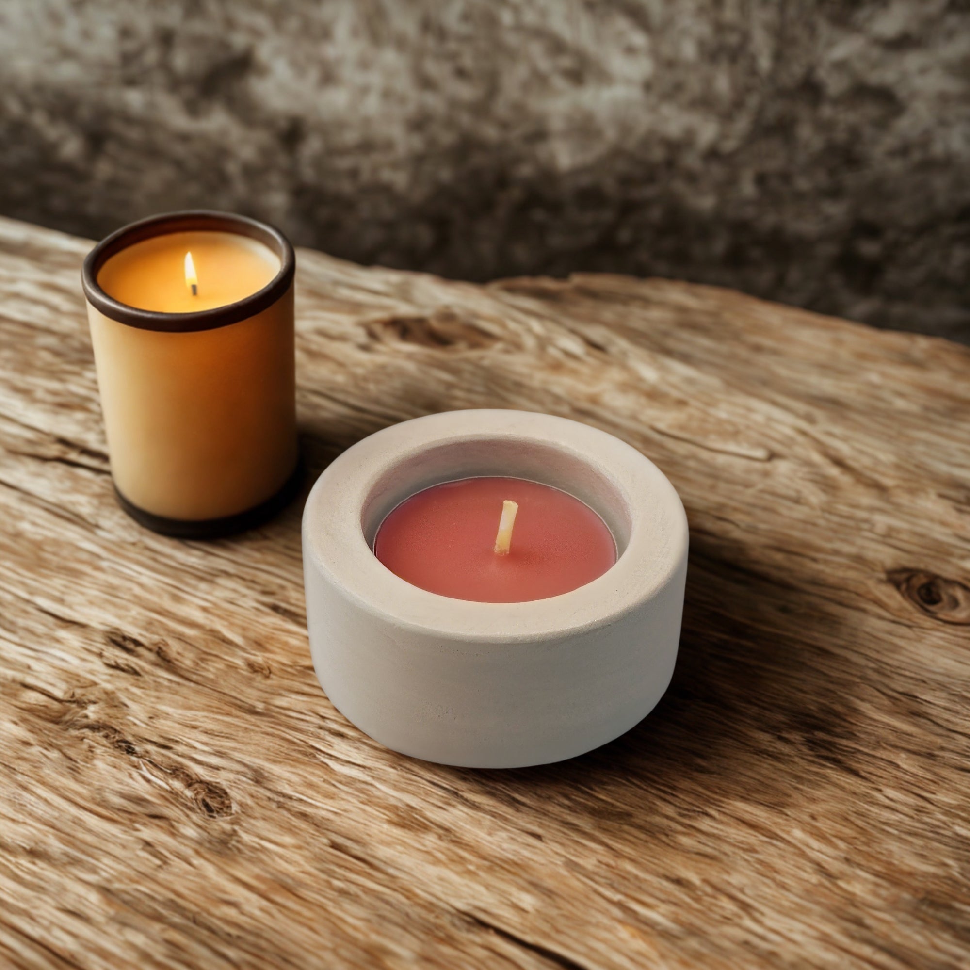 two tealight holders on a wooden desk