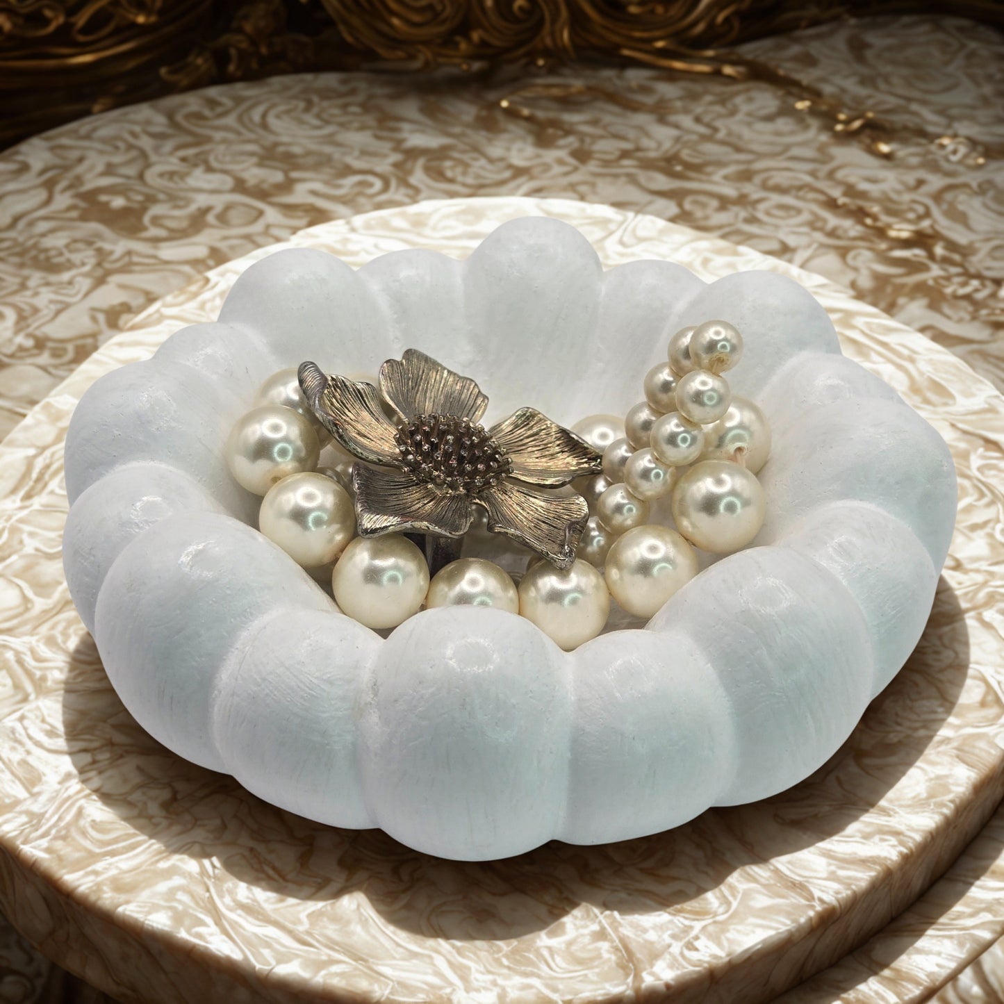Decorative Cloud Jewellery Bowl with pearls and a brooch on a patterned surface