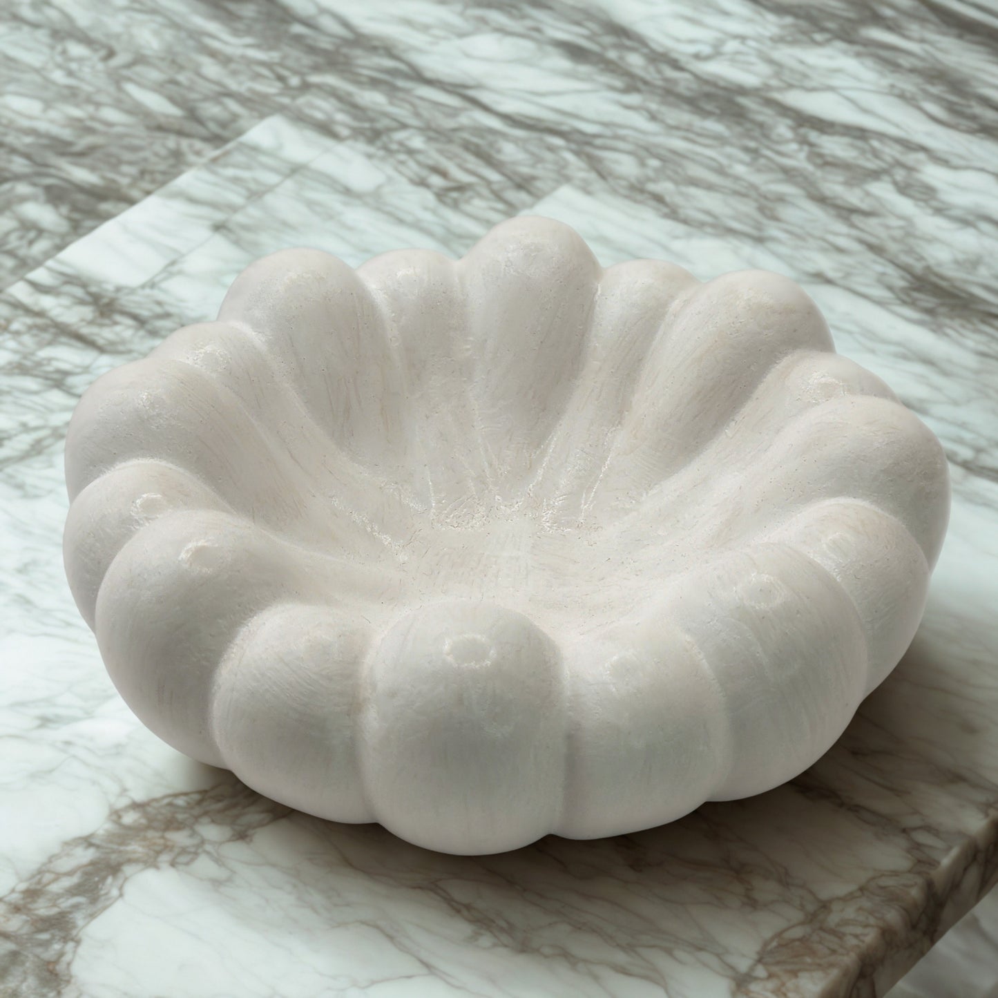 White stone bowl on a marble surface