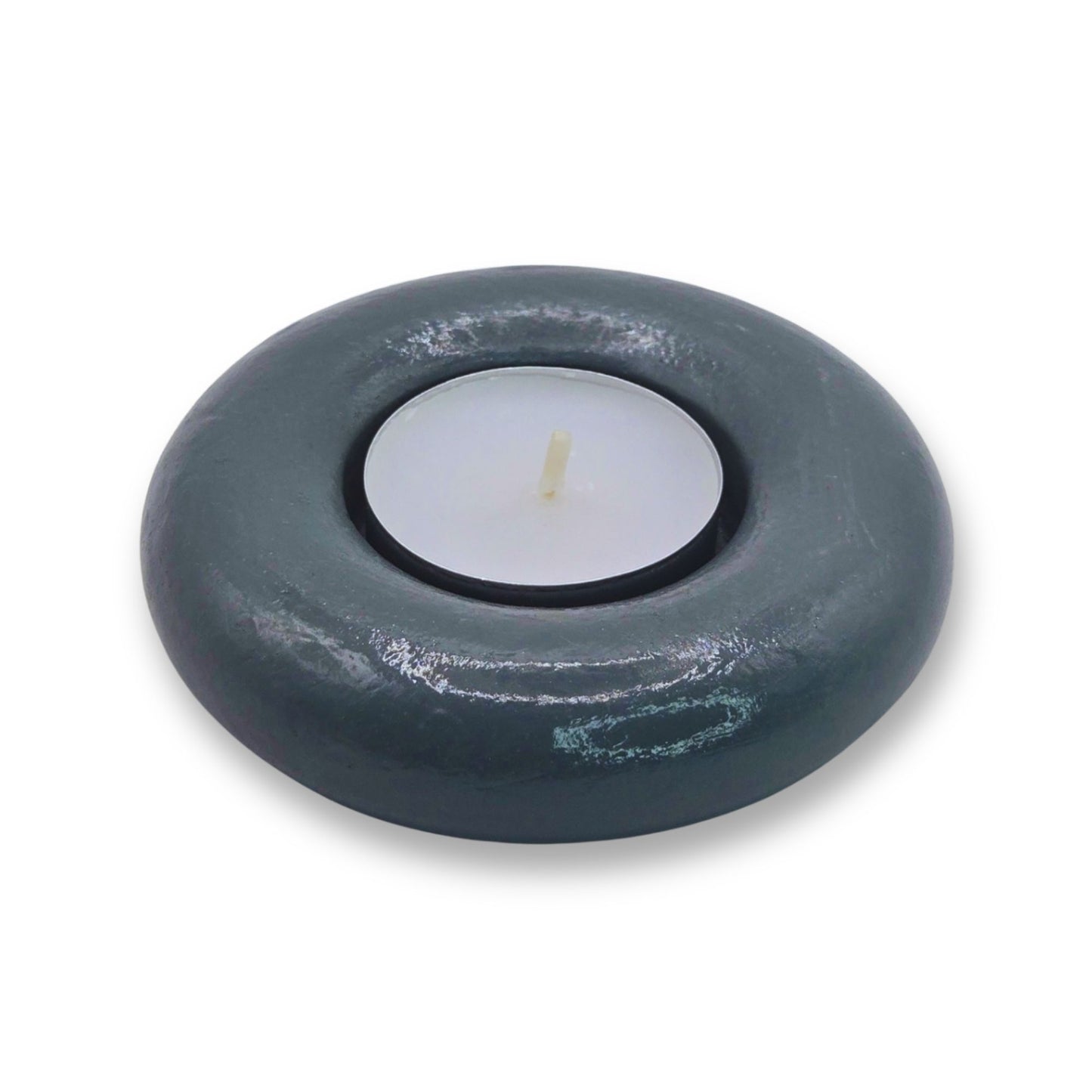 Gray candle holder with a white candle on a white background