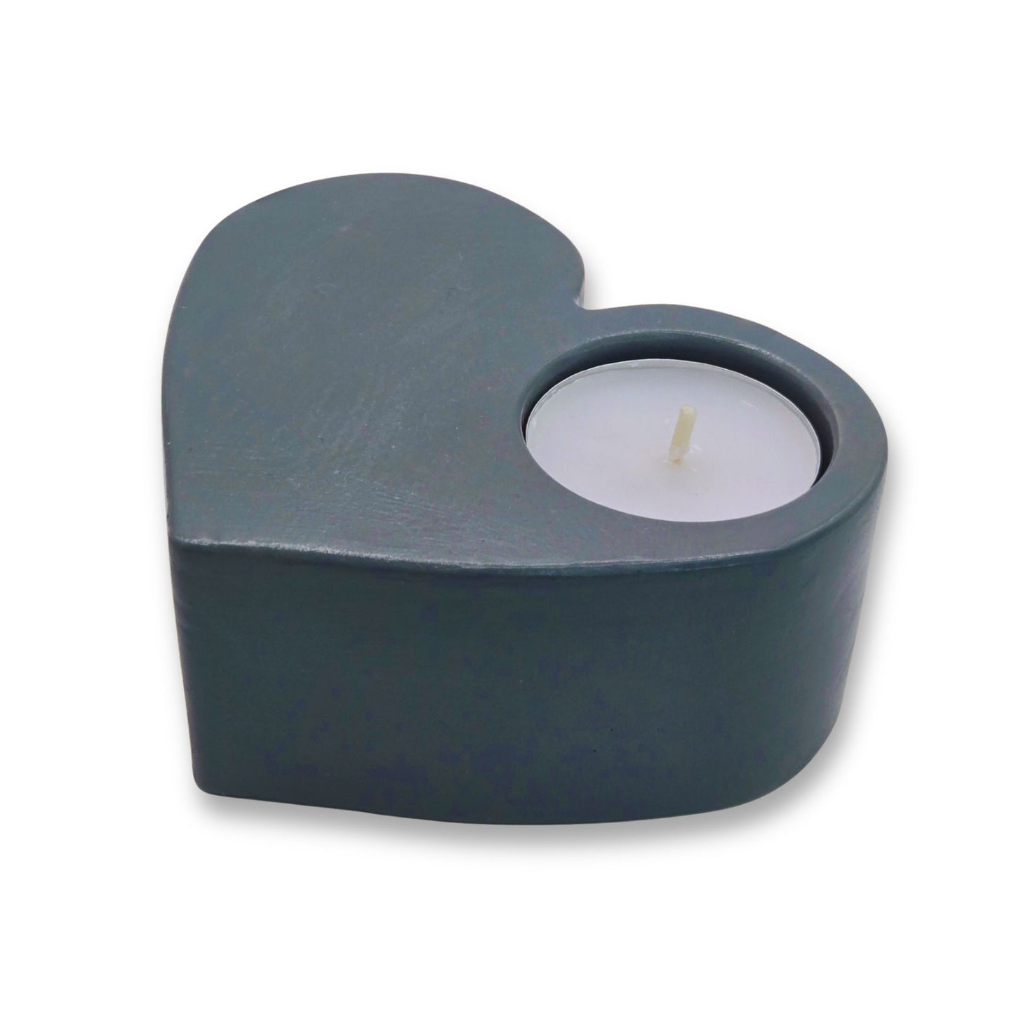 Heart-shaped grey candle holder with a lit candle on a white background