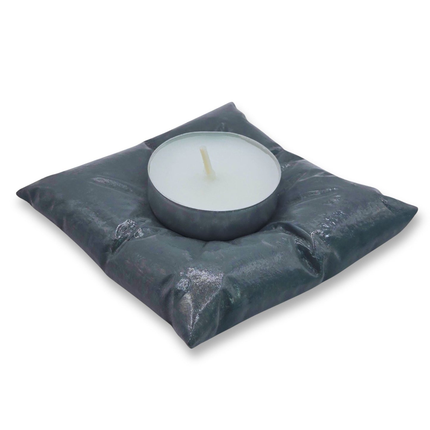 Candle in a gray cushion on a white background