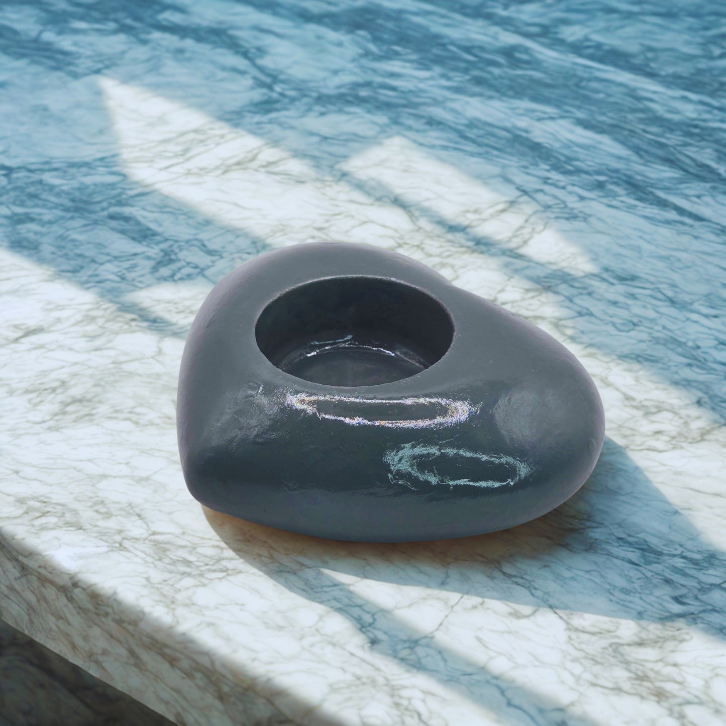 object on a marble surface with water in the background
