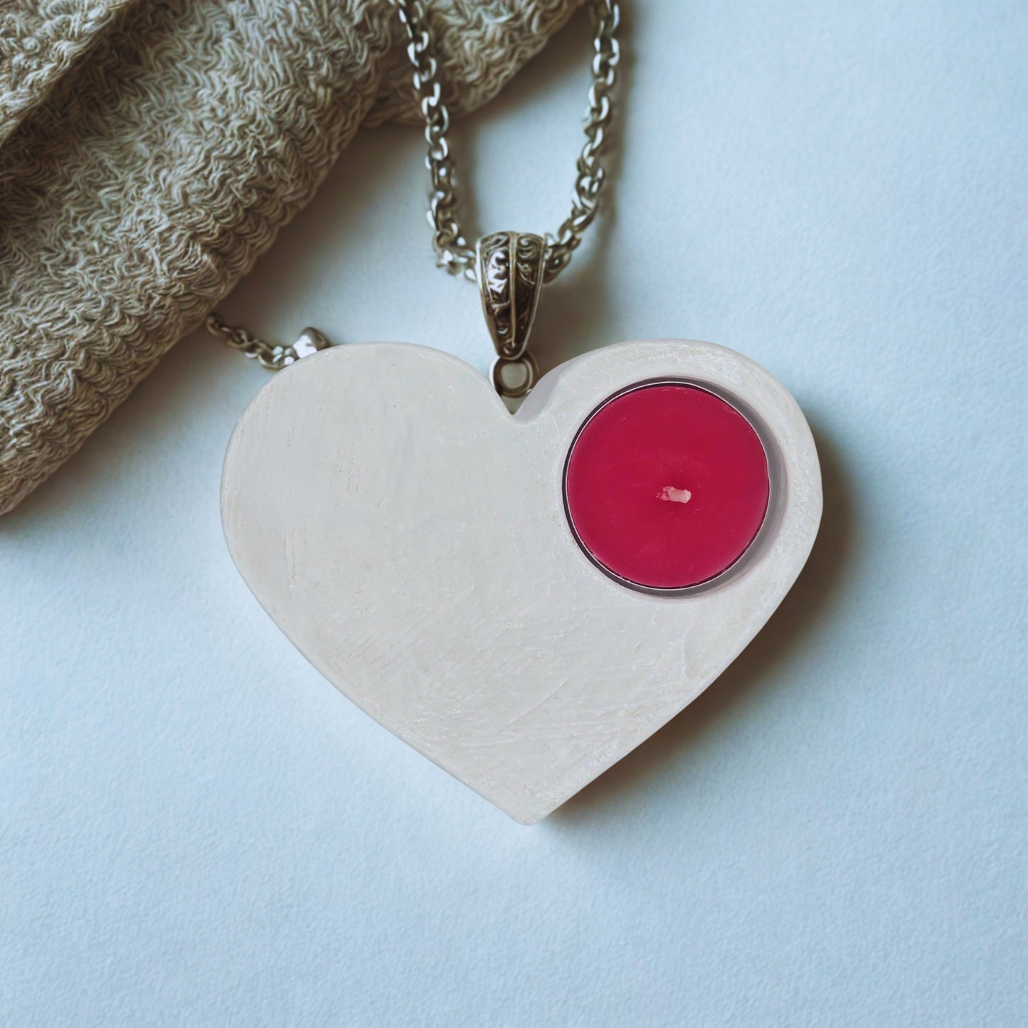 Heart-shaped holder with a pink center on a light blue background