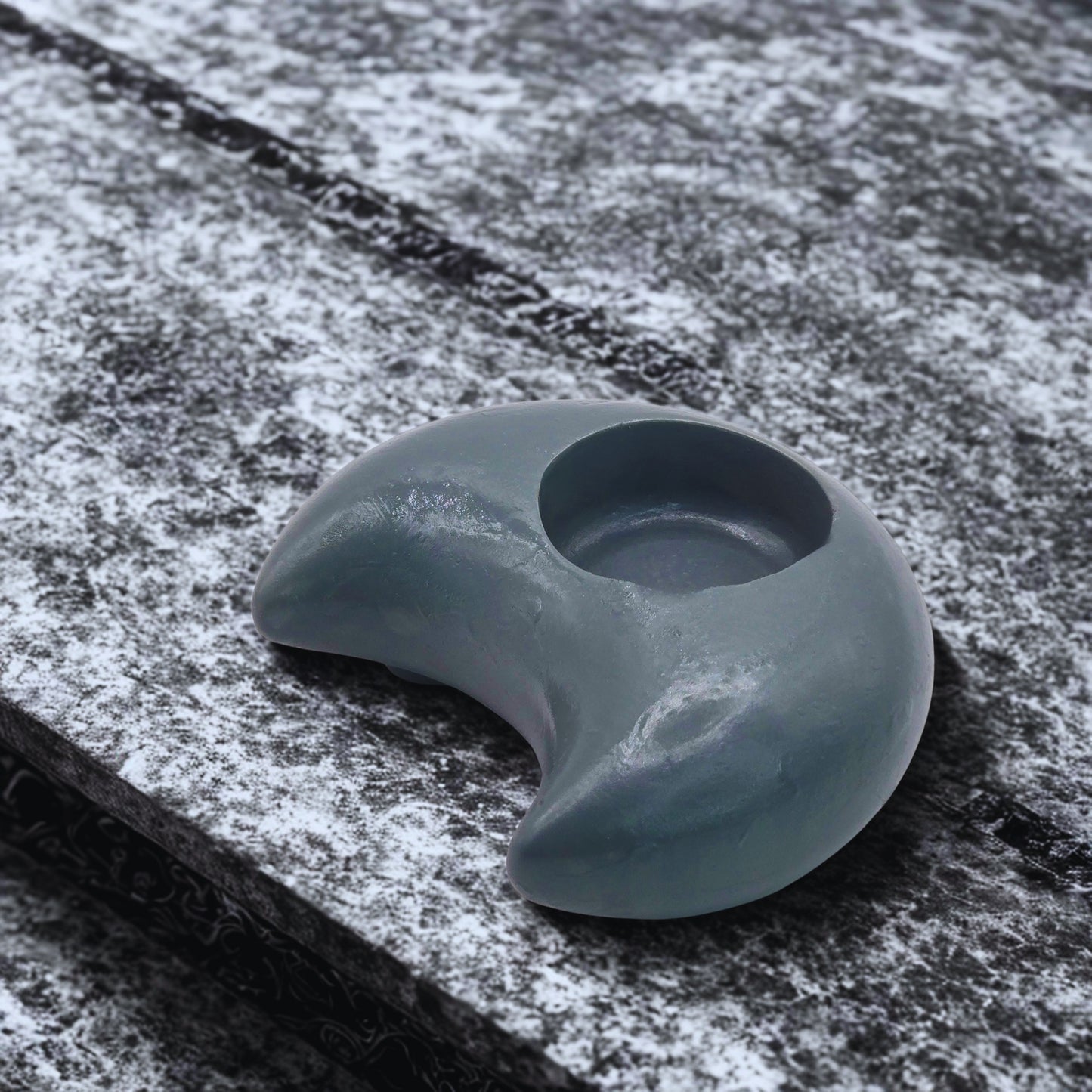 Gray Moon tealight holder on a textured surface