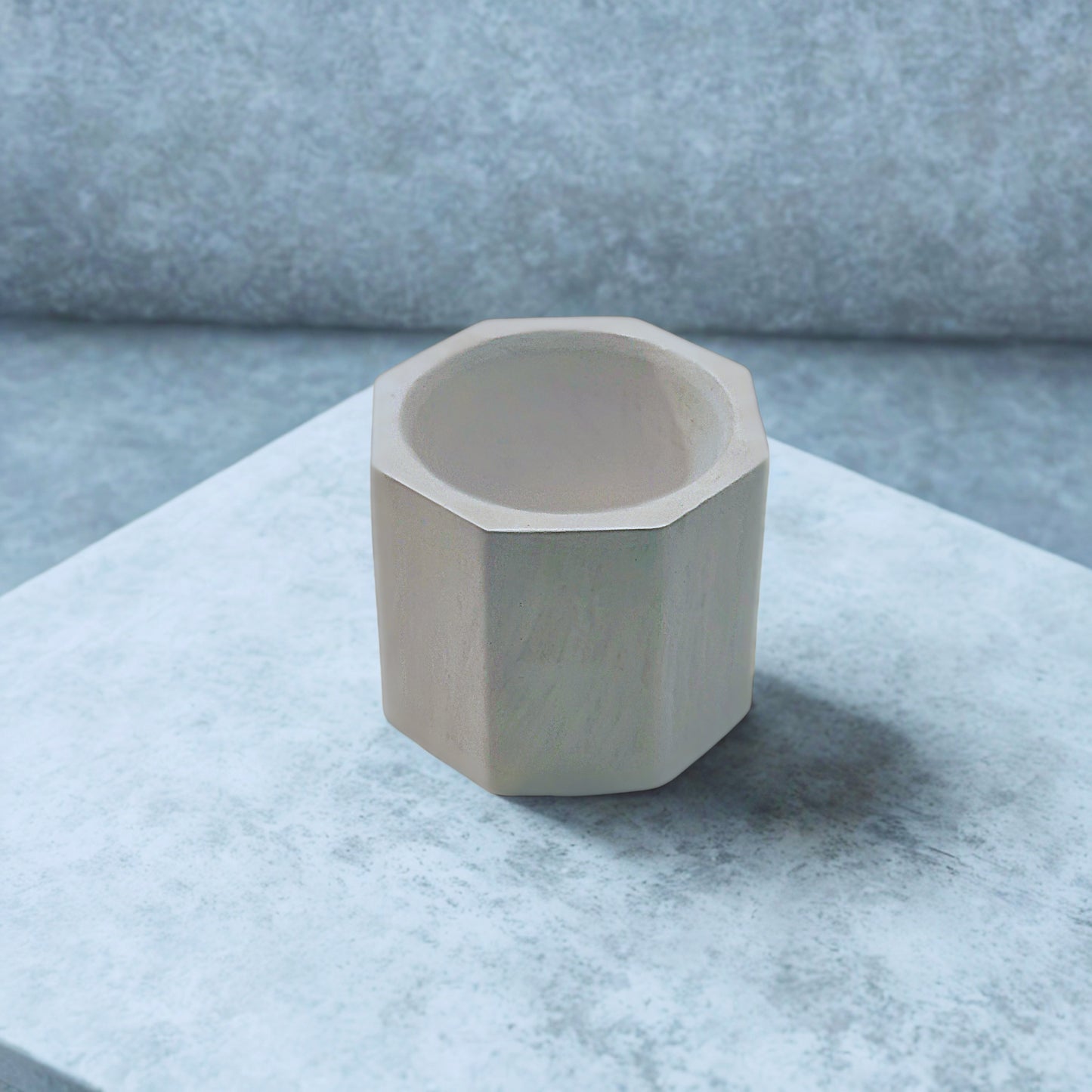 Octagon tealight holder on a marble surface with a neutral background