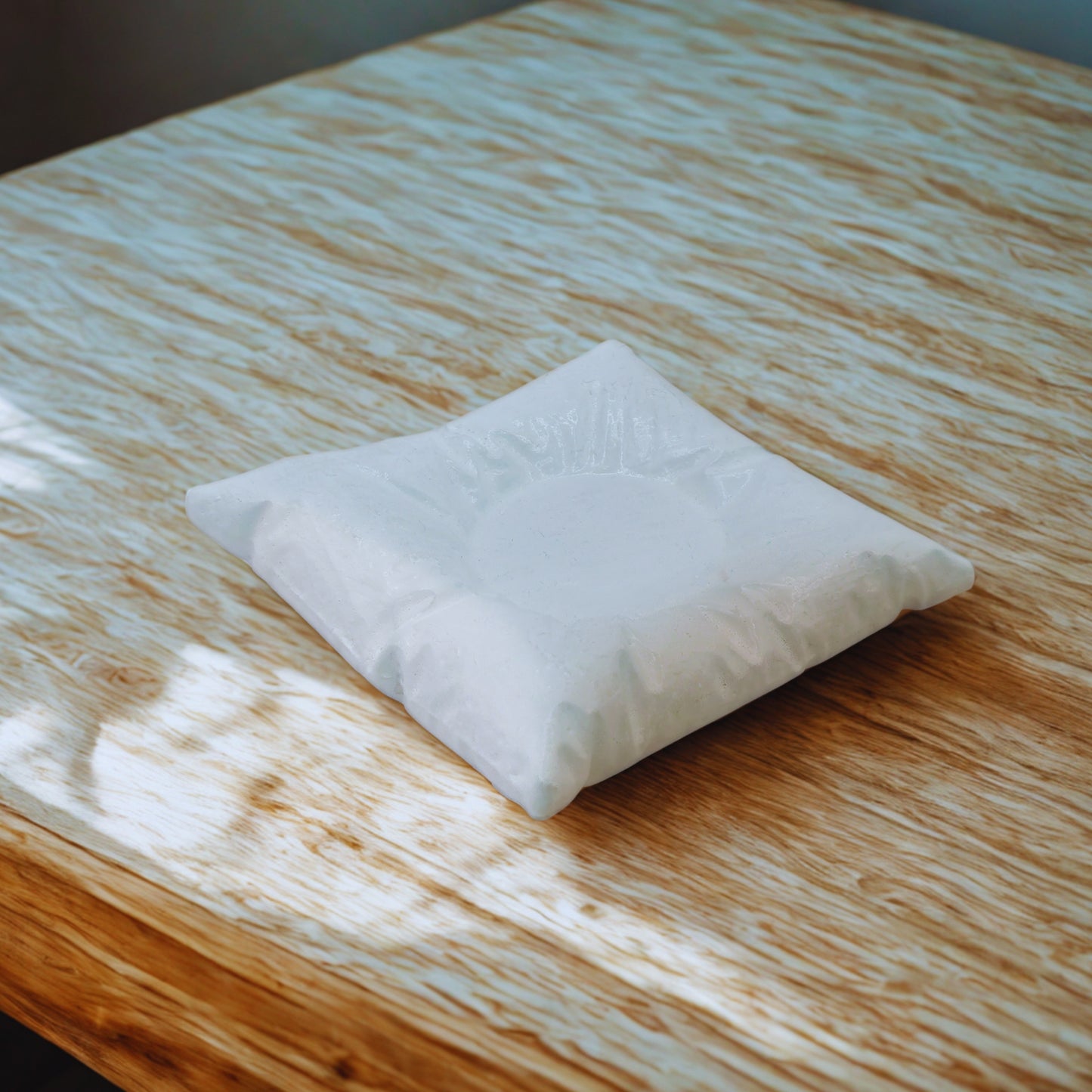 White pillow on a wooden surface