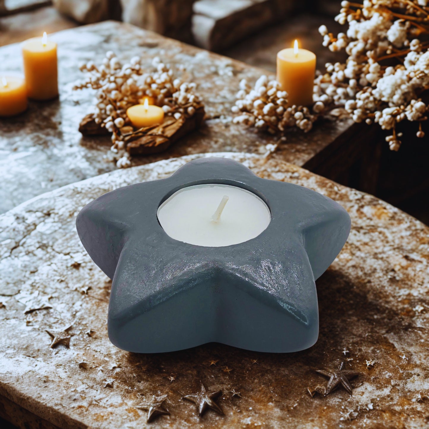 star tealight holder with a white candle on a rustic surface with candles and decorative elements.