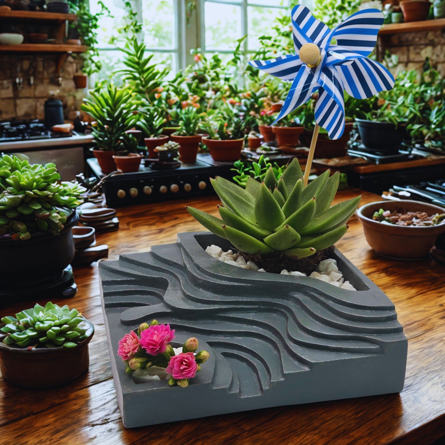 Decorative planter with a small garden of flowers and succulents on a wooden table with a pinwheel.