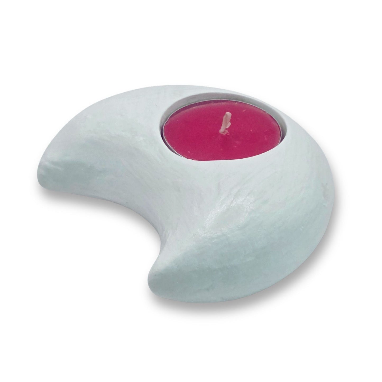Crescent-shaped candle holder with a pink candle on a white background