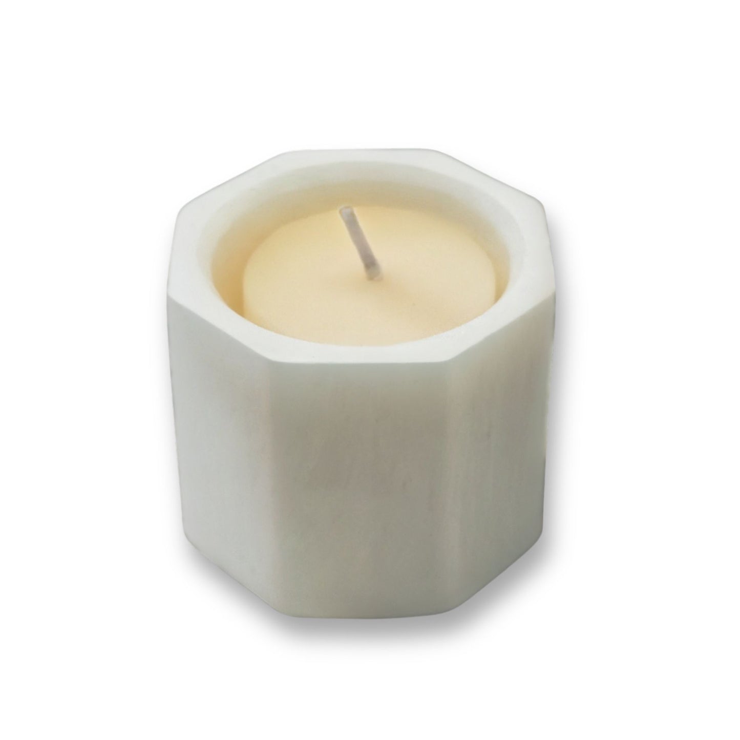 Hexagonal candle holder with a candle inside on a white background
