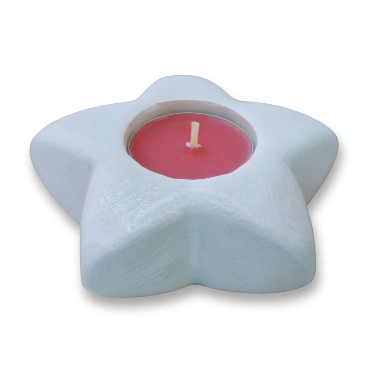 Star-shaped candle holder with a pink candle on a white background