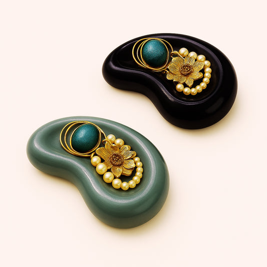 Two decorative items with floral designs and green and gold elements on a white background