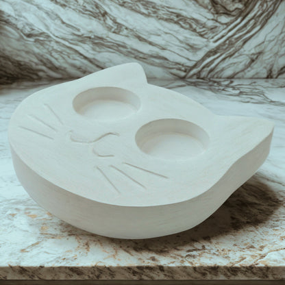 White cat tealight holder on a marble background