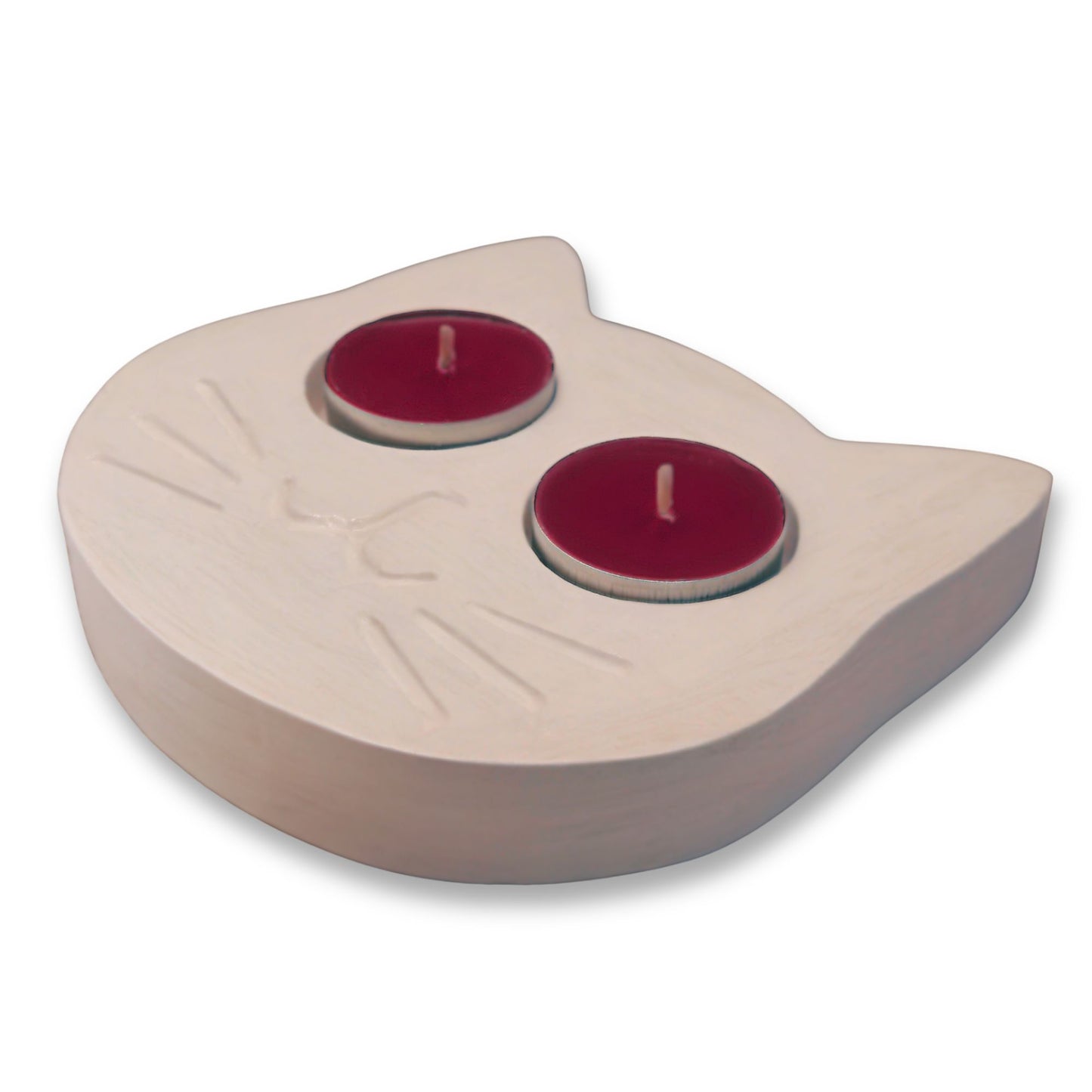 White cat tealight holder with two red candles on a white background