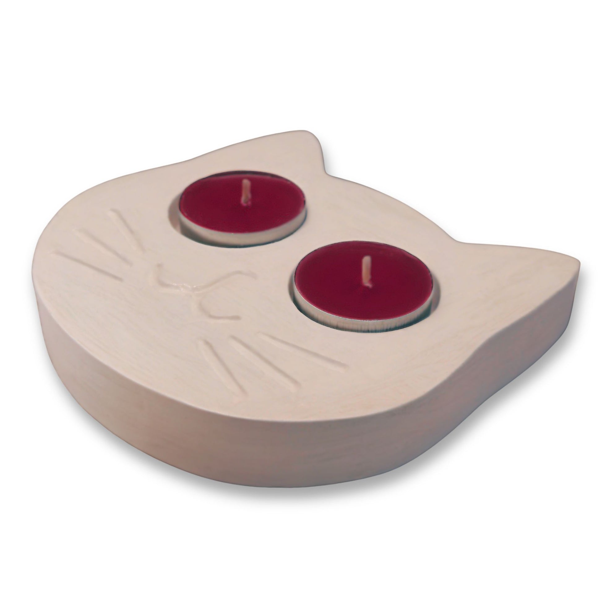 White cat tealight holder with two red candles on a white background