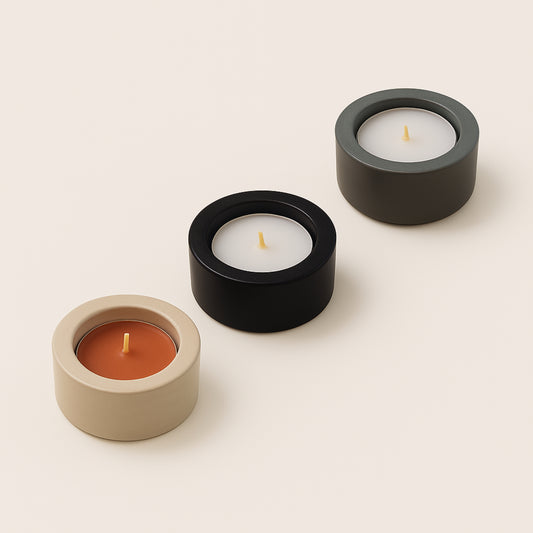 Three candles in different holders on a beige background