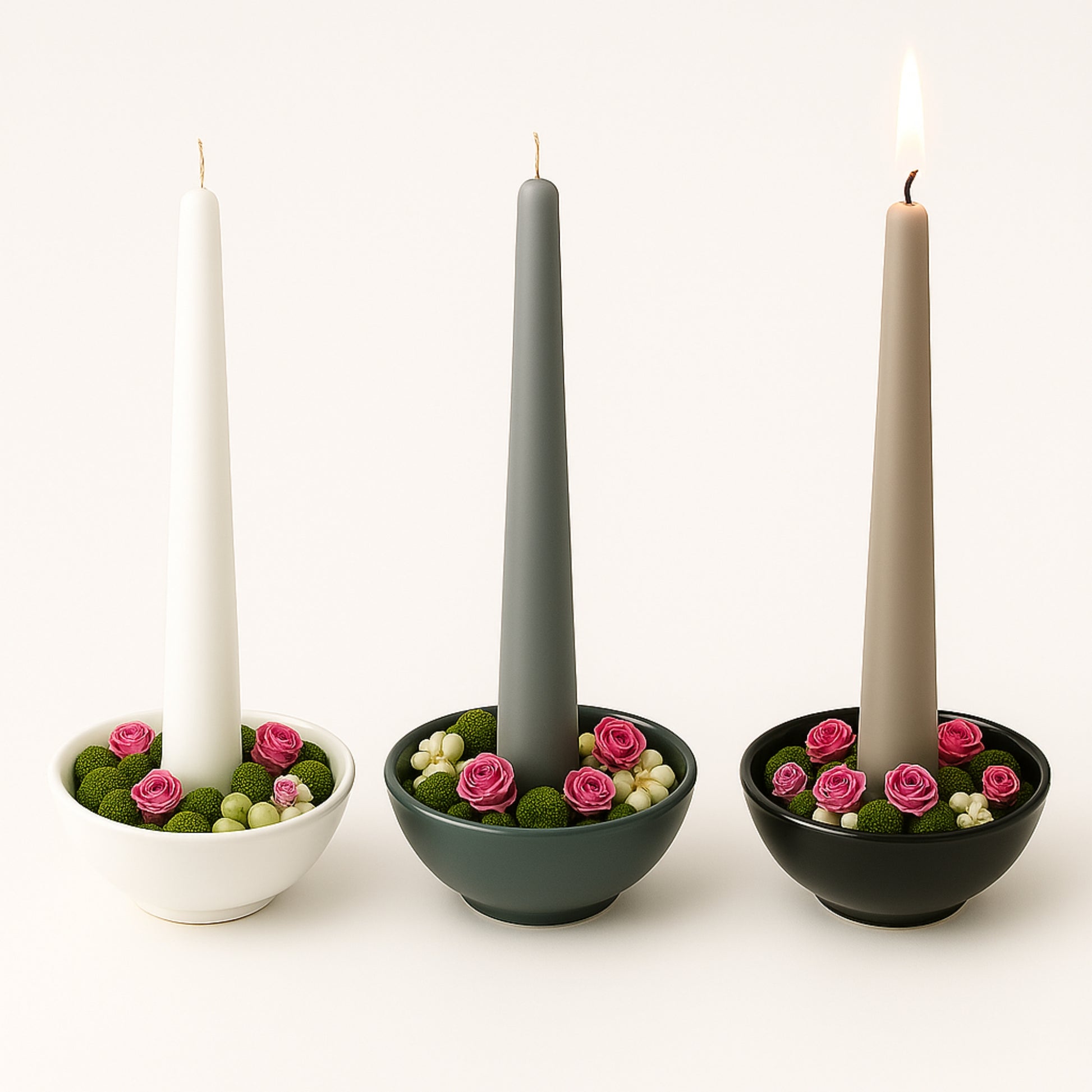 Three items with candles and decorative flowers on a white background