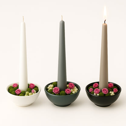 Three items with candles and decorative flowers on a white background