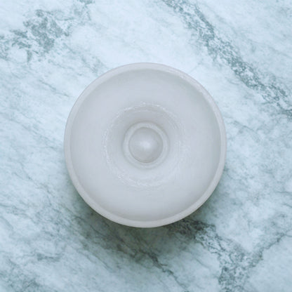 White round item on a marble surface