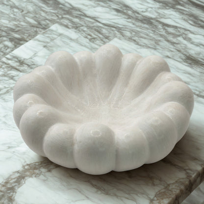 White stone bowl on a marble surface