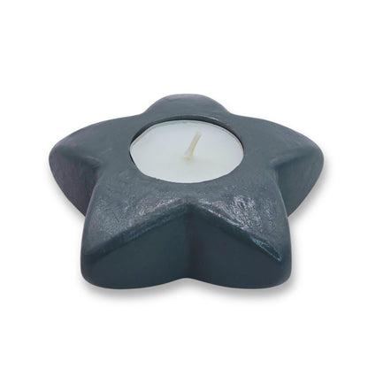 Star-shaped candle holder with a candle inside on a white background