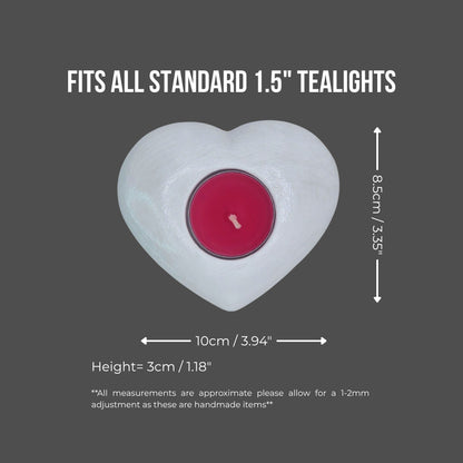 Heart-shaped candle holder with a red tealight on a gray background, showing measurements.