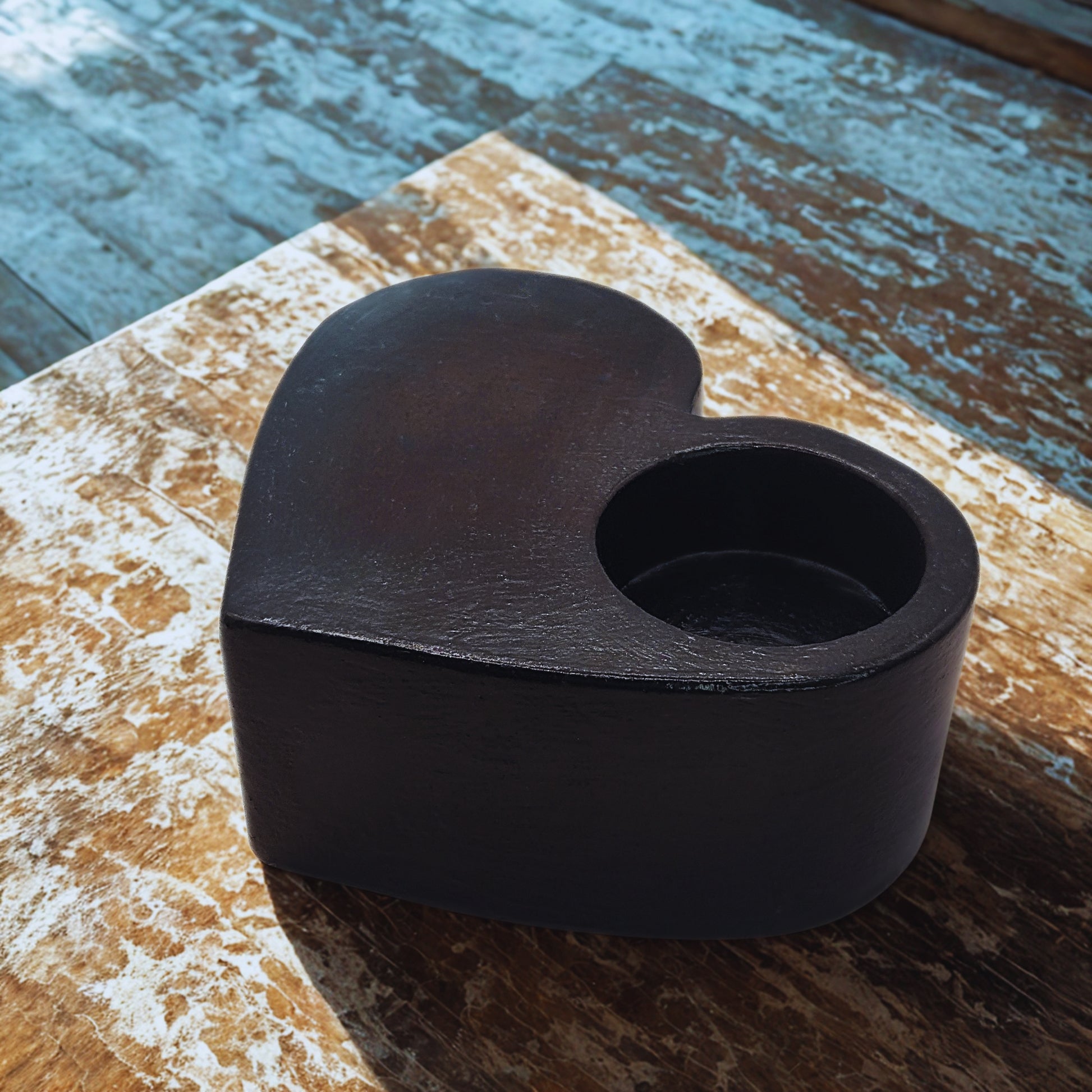 Black Large Heart tealight holder on a wooden surface