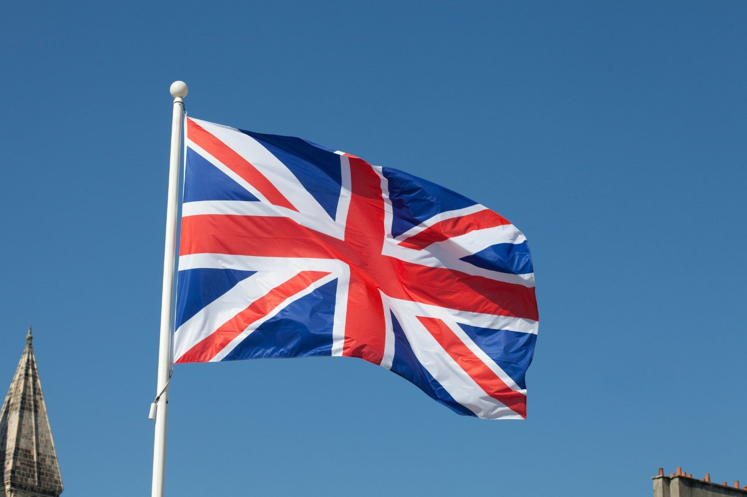 A union jack british flag flying in the wind