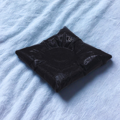 pillow tealight holder on a textured light blue surface