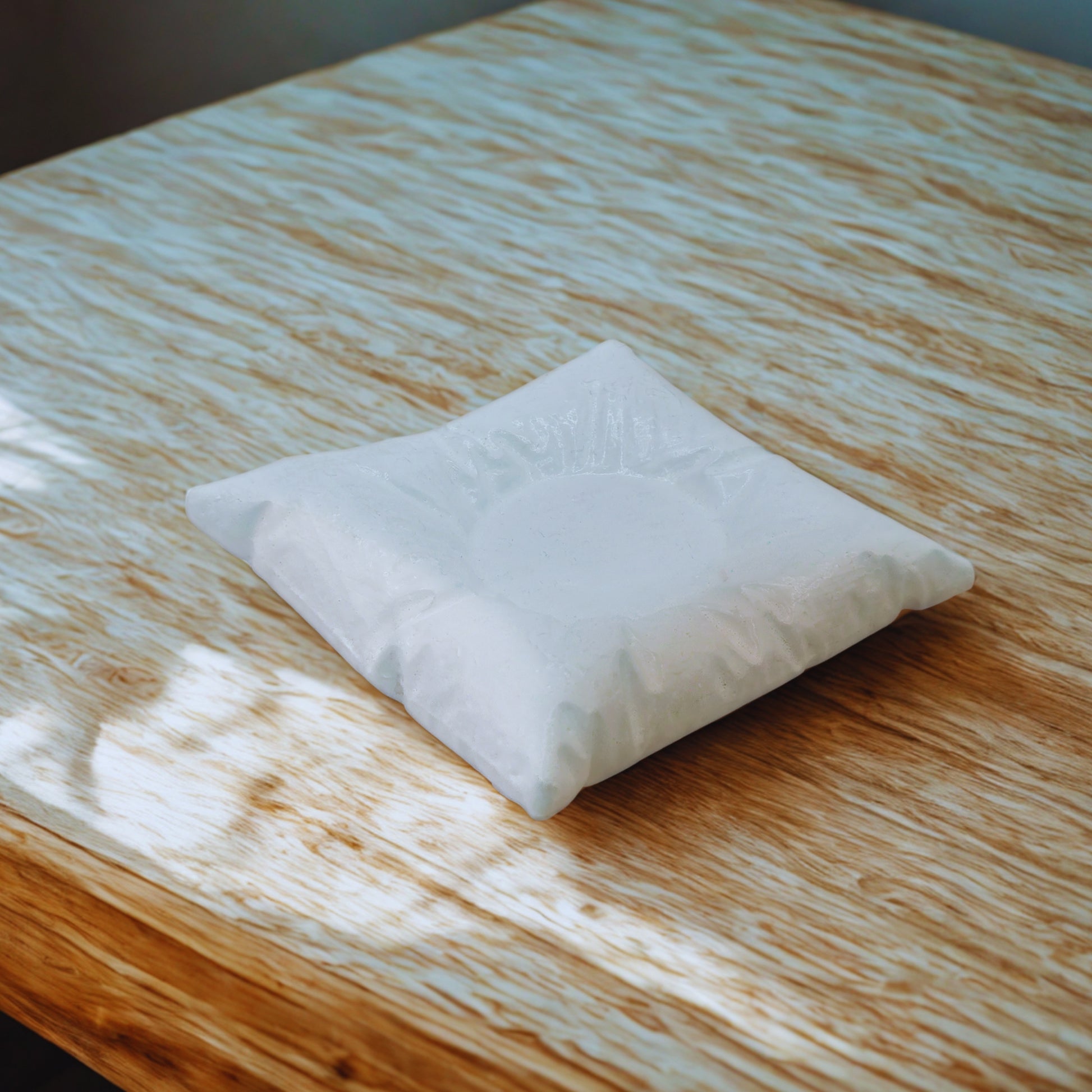 White pillow on a wooden surface