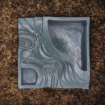 Decorative step planter with wavy pattern on a brown surface