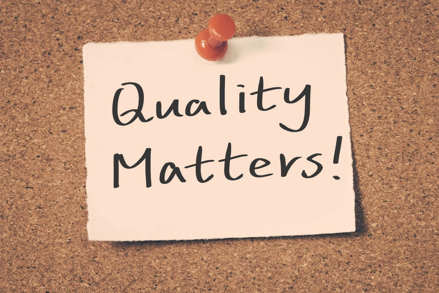 A note pinned to a corkboard saying 'Quality Matters'