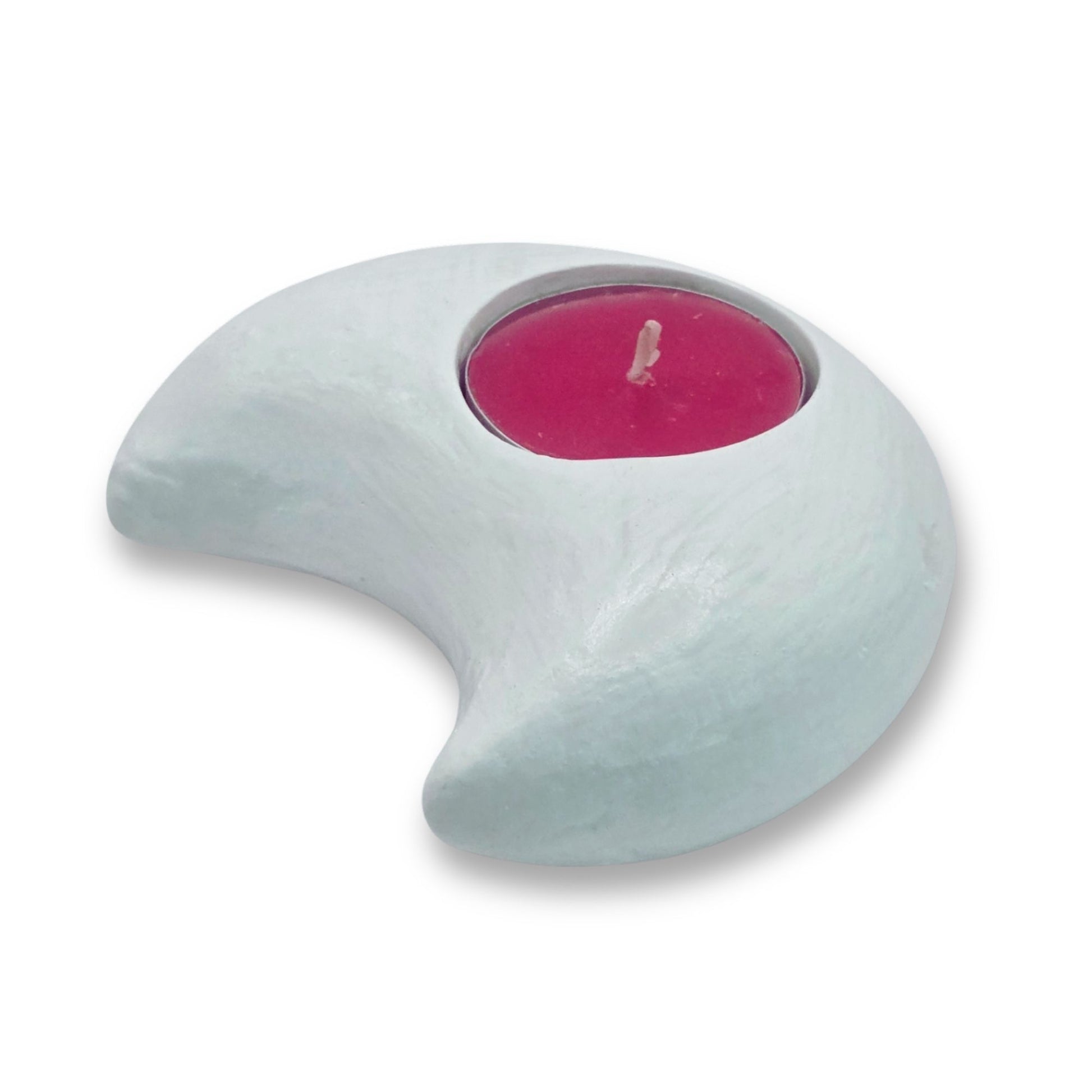 Crescent-shaped candle holder with a pink candle on a white background